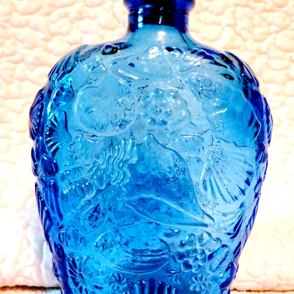 Blue Glass Beautifully decorated bottle with cork.  Approx 7 inches tall